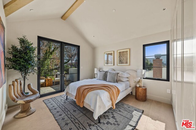 bedroom with lofted ceiling with beams, access to exterior, and light hardwood / wood-style floors