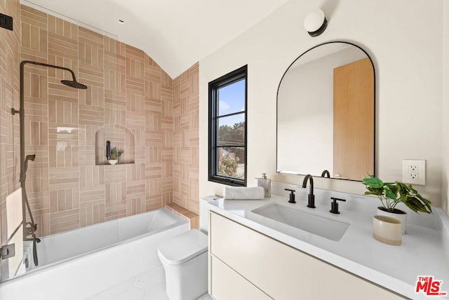 full bathroom featuring bathing tub / shower combination, vaulted ceiling, vanity, and toilet