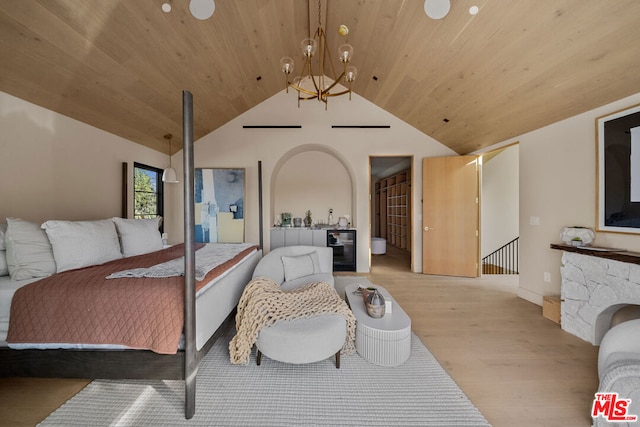 bedroom with vaulted ceiling, wooden ceiling, an inviting chandelier, and light hardwood / wood-style flooring