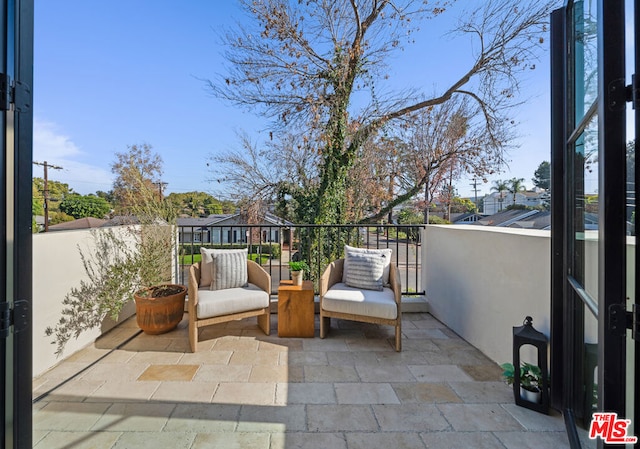 view of patio featuring a balcony