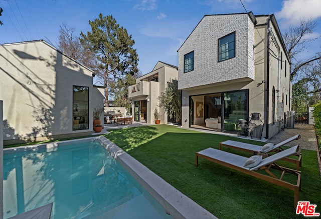 back of property with central AC unit, a yard, an outdoor hangout area, and a patio area