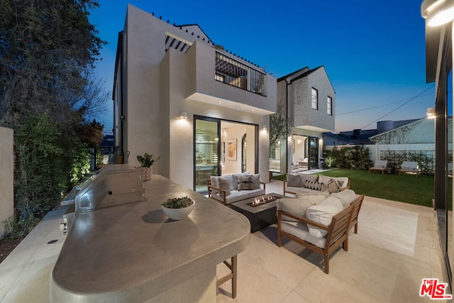 patio terrace at dusk with a balcony and an outdoor hangout area