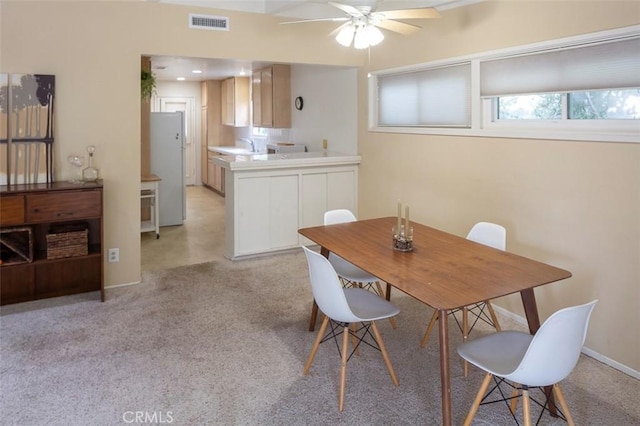 dining room featuring sink and ceiling fan