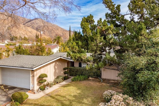 exterior space with a mountain view and a garage