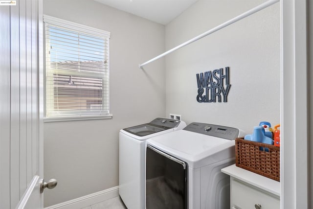 clothes washing area with washer and clothes dryer