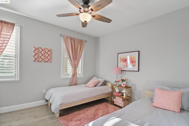 bedroom with ceiling fan and light wood-type flooring