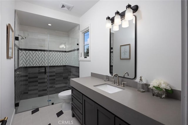 bathroom featuring a shower with shower door, tile patterned floors, vanity, and toilet