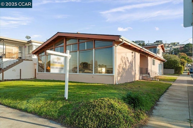 view of side of home featuring a lawn