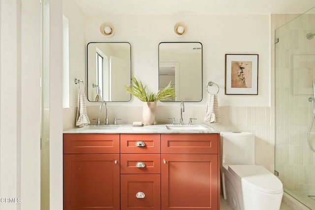 bathroom with tile walls, toilet, vanity, and walk in shower