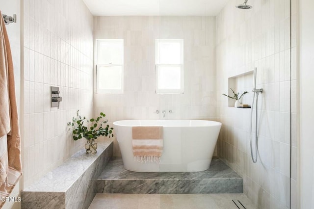 bathroom with separate shower and tub, tile walls, and tile patterned floors