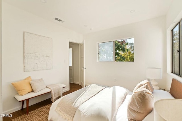 bedroom with dark hardwood / wood-style floors