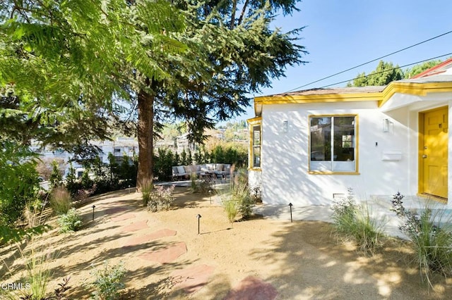 view of side of property with a patio area