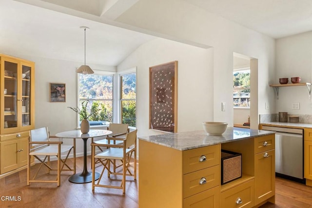 kitchen featuring dishwasher, pendant lighting, a center island, light wood-type flooring, and light stone counters