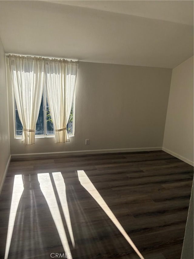 empty room with dark hardwood / wood-style floors