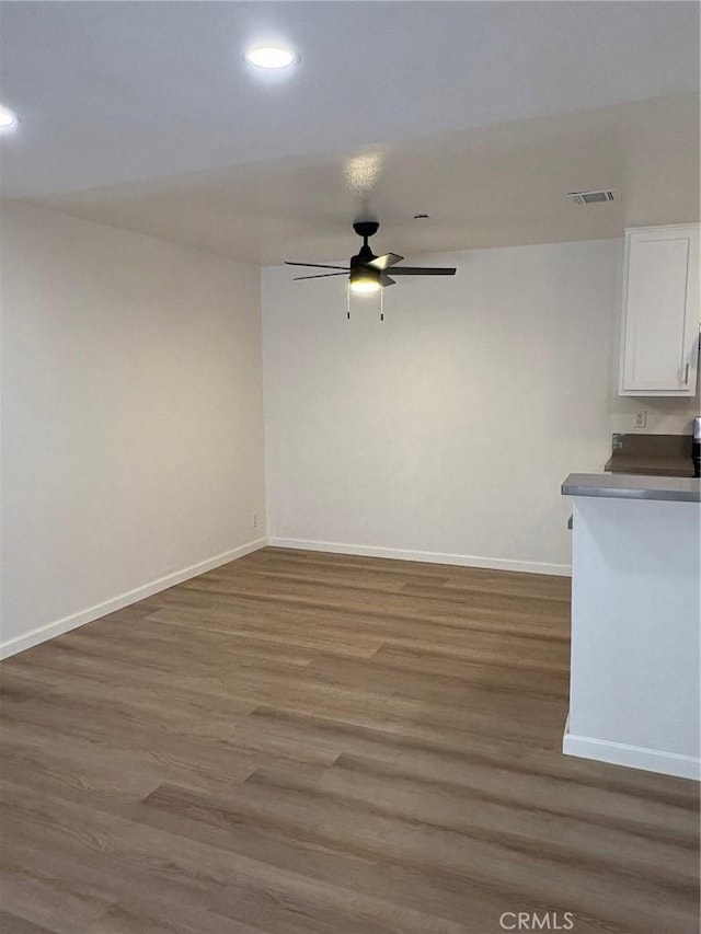 spare room with dark hardwood / wood-style floors and ceiling fan