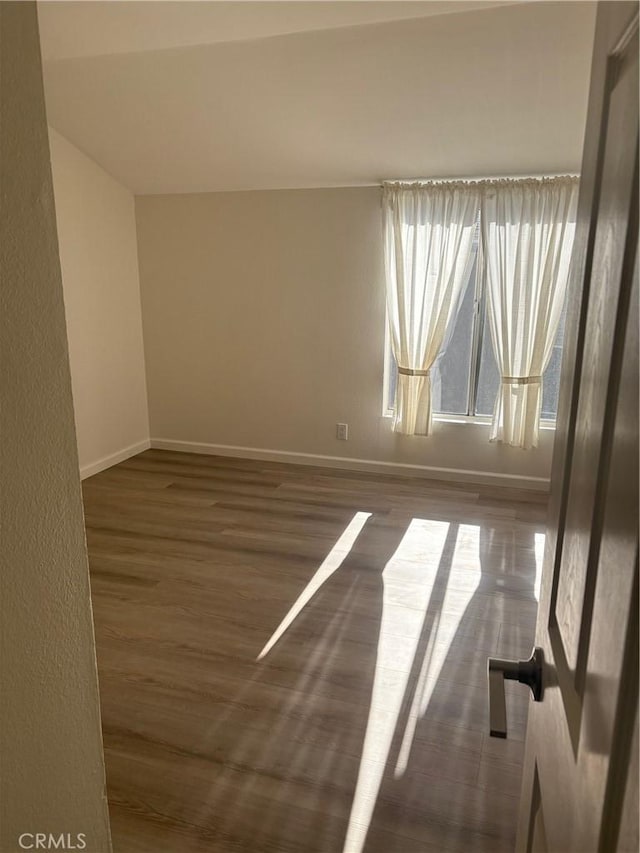 empty room with dark wood-type flooring