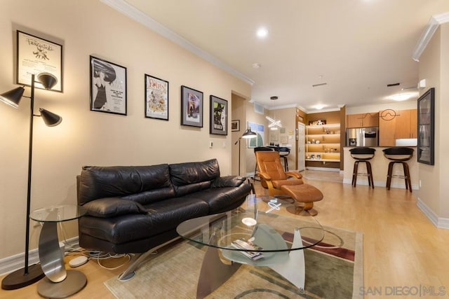 living room featuring crown molding and light hardwood / wood-style flooring