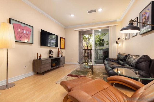 living room with hardwood / wood-style flooring and crown molding