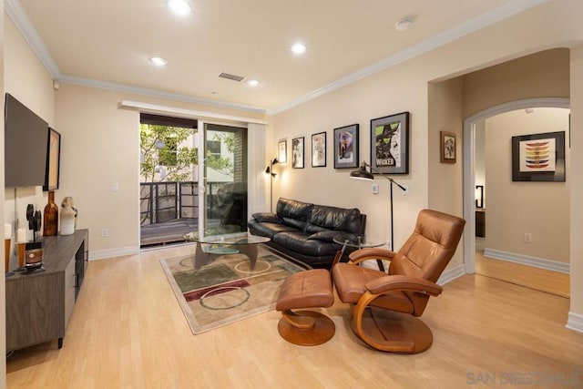 living room featuring crown molding and light wood-type flooring