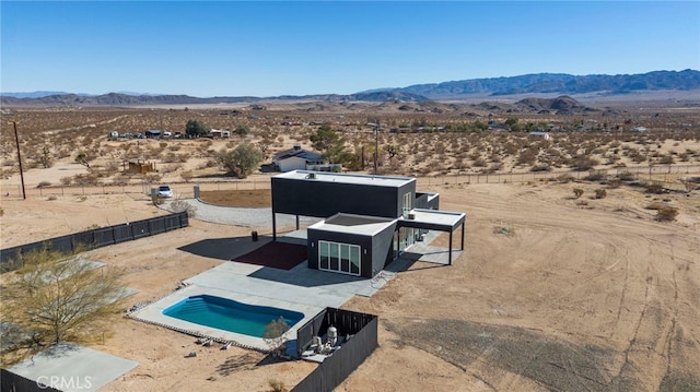 birds eye view of property with a mountain view