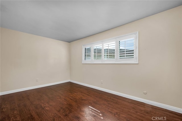 spare room with wood-type flooring