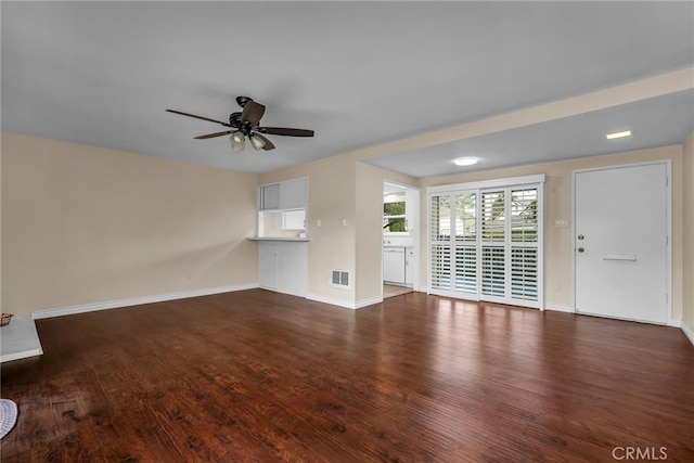 unfurnished living room featuring ceiling fan and dark hardwood / wood-style flooring