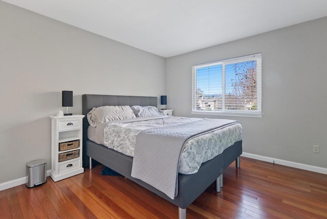 bedroom with dark hardwood / wood-style floors