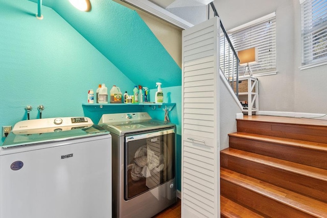 laundry area featuring a wealth of natural light and washer and clothes dryer