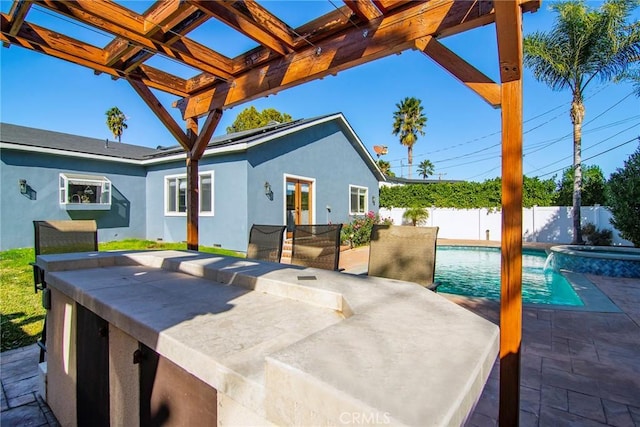 view of patio / terrace featuring exterior bar and a fenced in pool