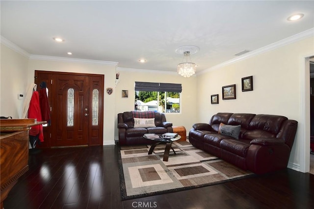 living room featuring dark wood-type flooring, an inviting chandelier, and ornamental molding