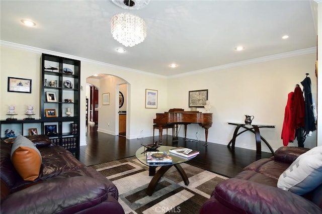 living room with dark hardwood / wood-style floors, ornamental molding, and a chandelier