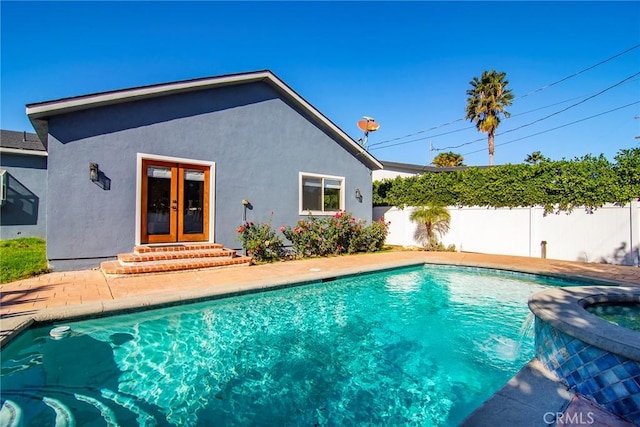 view of pool with french doors