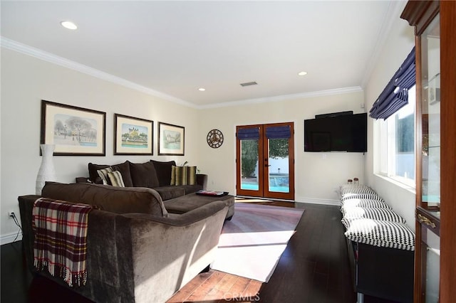 living room with dark hardwood / wood-style floors, crown molding, and french doors