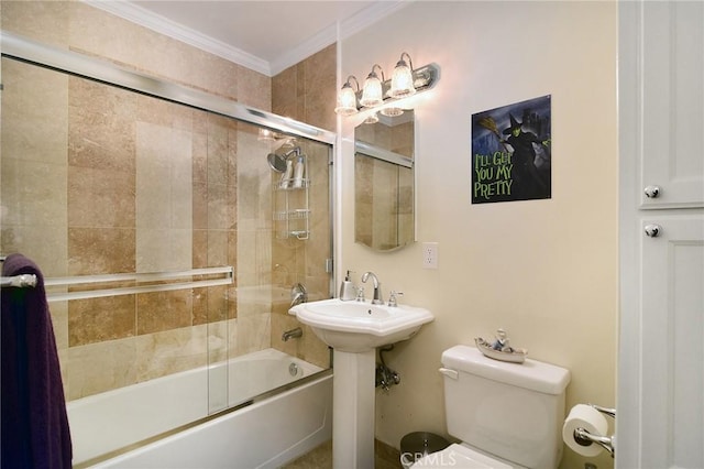 bathroom with toilet, combined bath / shower with glass door, and crown molding