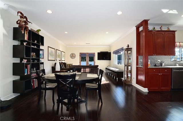 dining room with dark wood-type flooring and crown molding