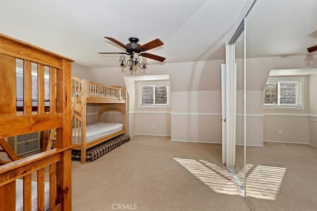 bedroom featuring vaulted ceiling, ceiling fan, and light colored carpet