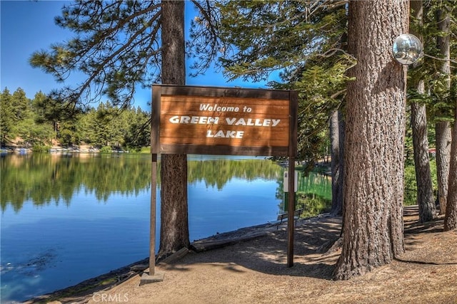 community sign with a water view