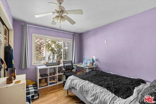 bedroom with light hardwood / wood-style flooring and ceiling fan