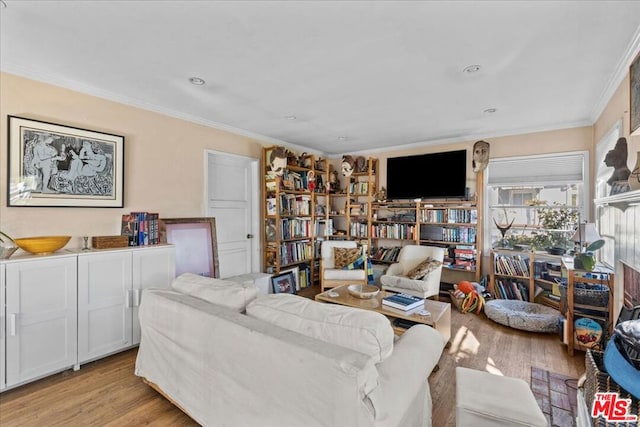 living room with light hardwood / wood-style flooring and ornamental molding