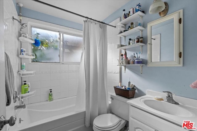 full bathroom featuring shower / tub combo with curtain, vanity, and toilet