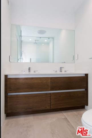 bathroom featuring toilet and vanity