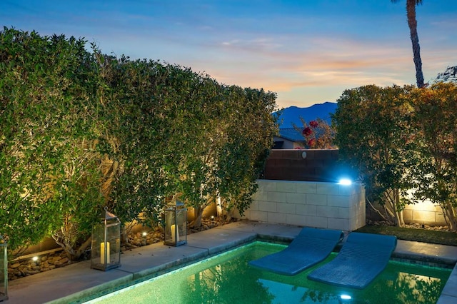 pool at dusk with a mountain view