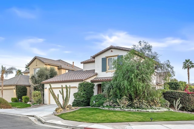 mediterranean / spanish-style house with a garage and a front yard