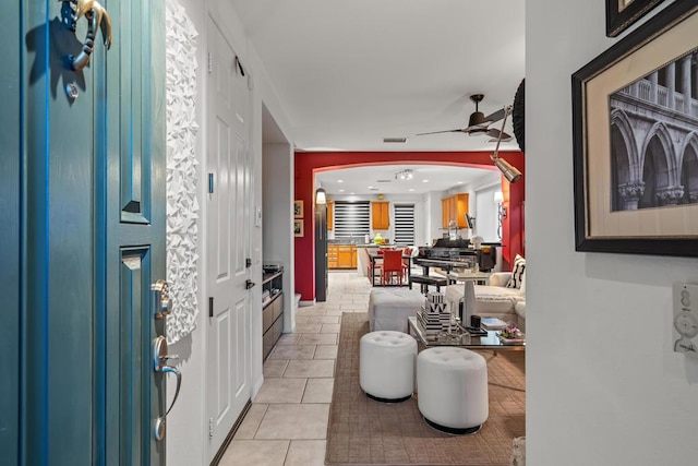 tiled foyer entrance featuring ceiling fan