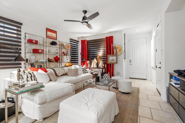 tiled living room featuring ceiling fan and plenty of natural light