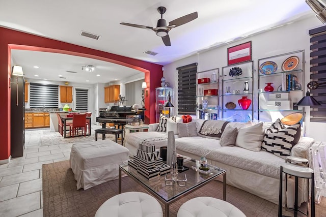 tiled living room featuring ceiling fan