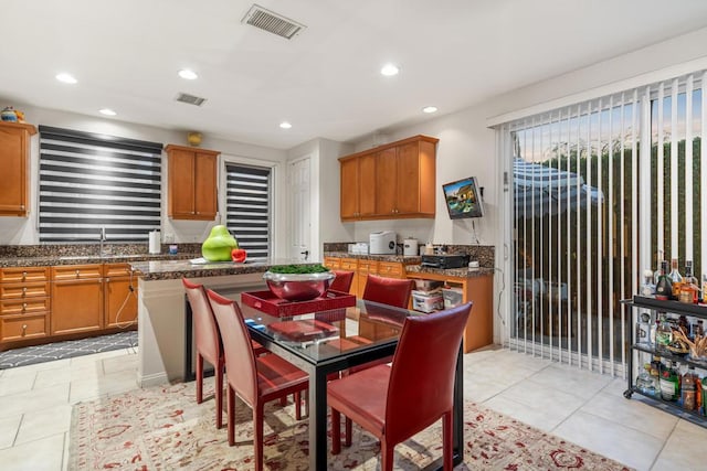 kitchen featuring sink and light tile patterned flooring