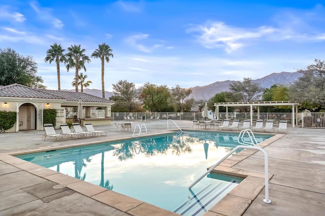 view of pool with a mountain view and a patio