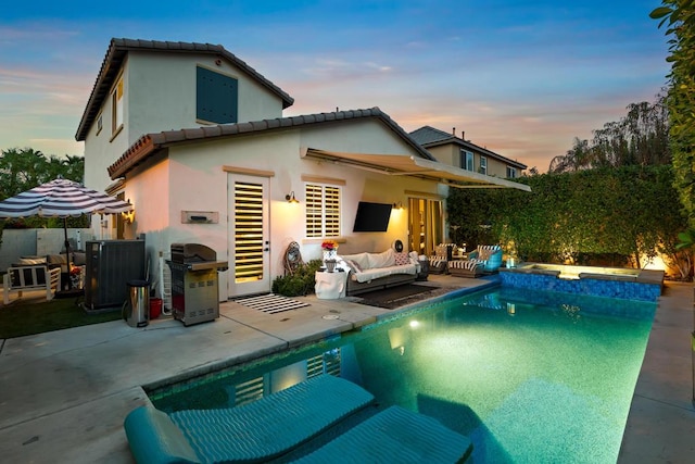 back of house featuring a fenced in pool, an outdoor living space, and a patio