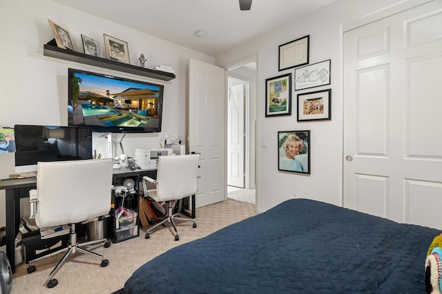 bedroom featuring ceiling fan and light colored carpet